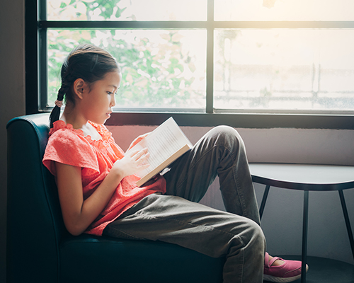 stock photo of girl reading by window